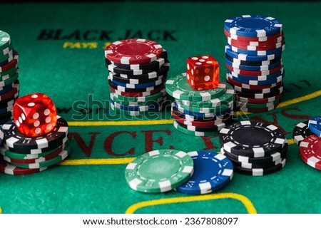 Stack of green, red, blue, white and black Playing Poker Chips in a green background Royalty-Free Stock Photo #2367808097