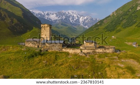 The Orthodox Church in the mountains. Church in the village of Ushguli, North Svaneti, Georgia. Medieval Church. Orthodox religion. Arial View of Svanetia, summer natural landscape, nature of Georgia.