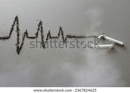 Cigarettes and cardiogram made of ash in fumes of smoke, harmful effects of cigarette smoking, creative concept  Royalty-Free Stock Photo #2367824625