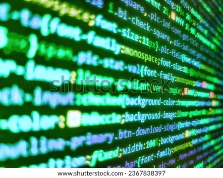 Web development work concept. Failure in the program, blue screen, programming. Minificated web development javascript code close up in sunset rays. Writing programming code on laptop