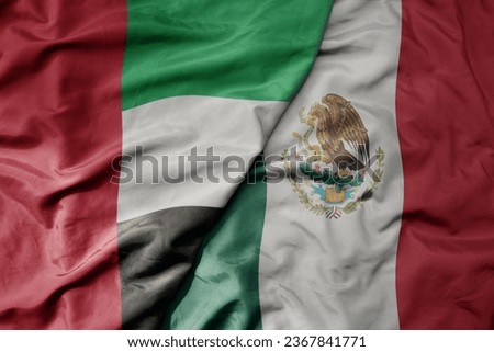 big waving realistic national colorful flag of united arab emirates and national flag of mexico . macro