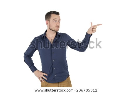 Young man pointing with his finger to one side against a white background