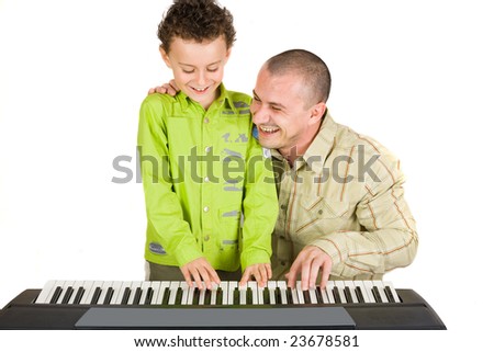 Father and son trying to play to a piano