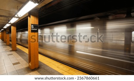 New York metro subway. Long exposure photo with a metro train arriving in 5th Avenue station. Public transportation in Manhattan.