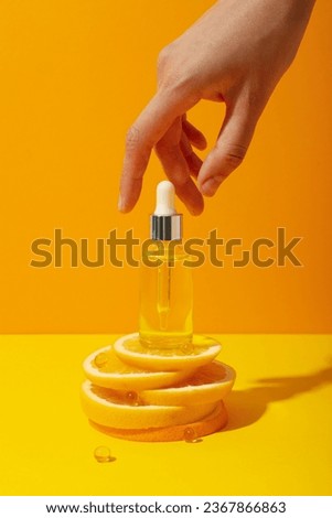 Vitamin C in liquid serum with citrus fruits.