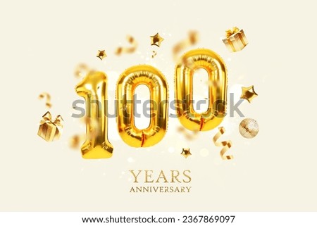 Gold Balloons 100 with golden gifts, confetti, stars and a mirrored balloon on a beige background with sparkles and bokeh lights. One hundred years Anniversary, creative idea. Luxury Card Royalty-Free Stock Photo #2367869097