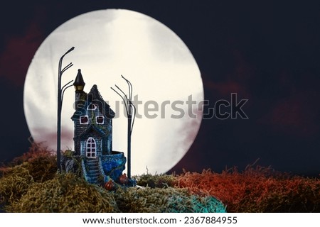 Halloween night with haunted house and full moon. Halloween holiday background.
