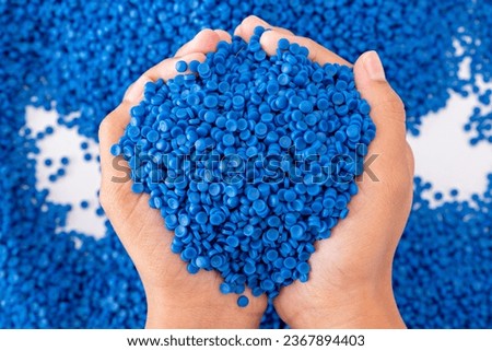 White plastic grain, plastic polymer granules,hand hold Polymer pellets, Raw materials for making water pipes, Plastics from petrochemicals and compound extrusion, resin from plant polyethylene. Royalty-Free Stock Photo #2367894403