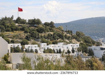 Bodrum city background. Aegean sea, traditional white houses, flowers, marina, sailing boats, yachts in Bodrum town Turkey
