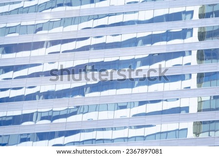 The modern building in the business district has glass windows to let in the light. Heat protection, reduce power consumption
