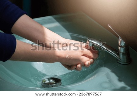 Wash your hands using hand sanitizer to kill germs that you might accidentally touch, such as the COVID-19 virus, before working or eating or doing other activities. Royalty-Free Stock Photo #2367897567