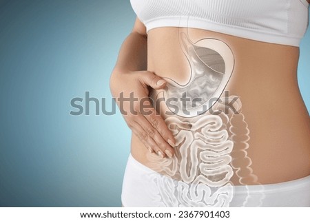 Woman with healthy digestive system on light blue background, closeup. Illustration of gastrointestinal tract Royalty-Free Stock Photo #2367901403