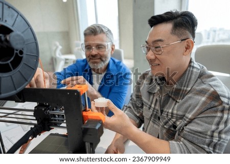 Scientists involved in setting up and developing 3D printers in the modern laboratory.