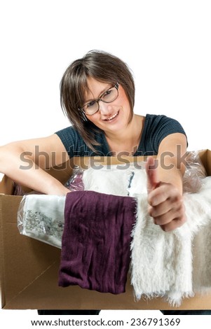 happy woman has cardboard-box with clothes on her knees