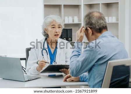 Asian female doctor and male patient talking health concept Royalty-Free Stock Photo #2367921899