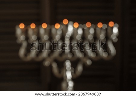 Jewish religious holiday Hanukkah with holiday Hanukkah (traditional candelabra) Blurred bokeh background, partial focus. Dark background
