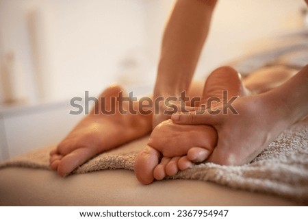 Skilled female masseur giving foot massage to young female.	
 Royalty-Free Stock Photo #2367954947