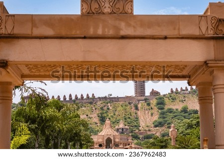 artistic carved red stone jain temple entrance with bright sky at morning image is taken at Shri Digamber Jain Gyanoday Tirth Kshetra, Nareli, Ajmer, Rajasthan, India on Aug 19 2023.