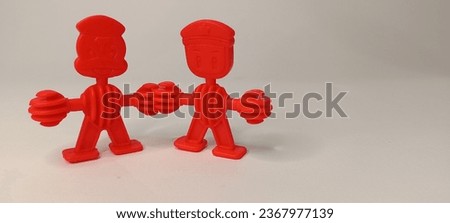 Jakarta, September 28 2023, 13.50. A red children's toy similar to Lego in the shape of a figure, with white as a background. photo taken from the side angle. 