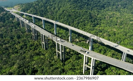 Aerial landscape of brazilian Imigrantes highway road at green forest trees and mountains. Traffic at road way to brazilian south coast. Legendary engineering construction. Brazil road landmark. Royalty-Free Stock Photo #2367986907