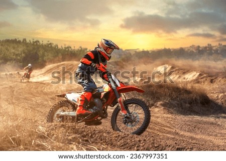 Enduro bike rider driving off road bike on sunset background. Preparing for competition. Training on motorbike. Extreme motorcycle Royalty-Free Stock Photo #2367997351
