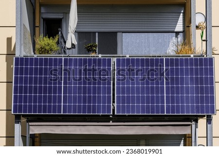 Two small Balcony Solar Panels energy system. Mini photovoltaic power plant. Solar battery on balcony wall of modern house in Germany. Mini PV plants generate your own electricity plug play. Royalty-Free Stock Photo #2368019901