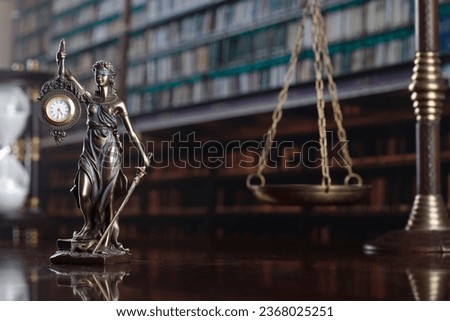 Law concept. Judge gavel, statue of justice, book background.