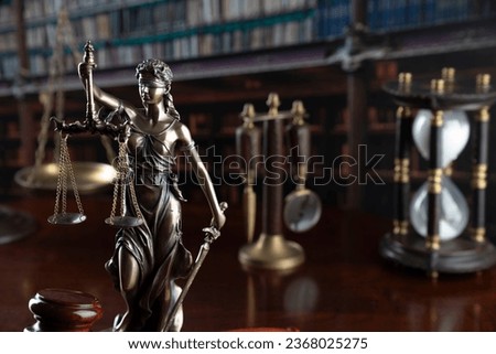 Law concept. Judge gavel, statue of justice, book background.