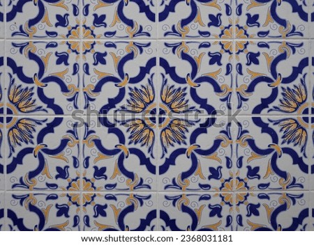Part of a typical Portuguese wall decorated with tiles. Nice blue, yellow and white colors. Portugal. Horizontal photo.