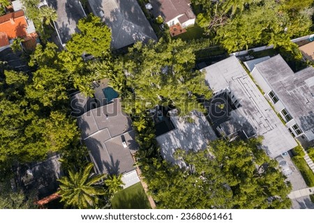 Aerial drone photoshoot footage in Florida, USA, commercial area, luxury houses, buildings and mansions, abundant tropical vegetation around, blue sky and Ocean.