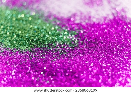 Macro shot of purple and green glitter spilled on a white background. Glitter banned from sale in Europe concept. Royalty-Free Stock Photo #2368068199