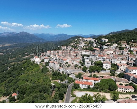 Picture of the village of Sartène in Corsica among green mountains.