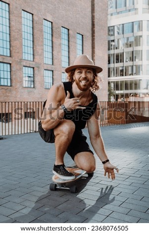 Vertical view of skateboarder riding at his skateboard through the streets