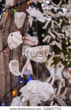 Beautiful decoration from coral and seashells and garland on the tree shine in the evening 