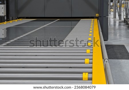 Group of glass sheets entering modern glass tempering furnace.  Royalty-Free Stock Photo #2368084079