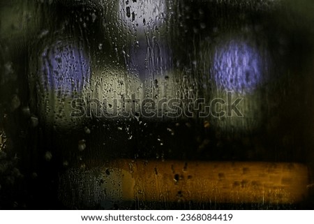 Window with rain drops in night