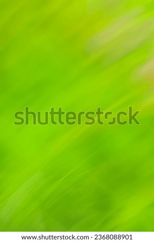 Slow shutter speed with motion green blur effect. Decorative green backdrop fast speedy motion no focus.