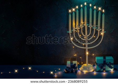Jewish Hanukkah Menorah 9 Branch Candlestick, gift box. Holiday Candle Holder. Nine-arm candlestick. Traditional Hebrew Festival of Lights candelabra. Background for design with copy space.