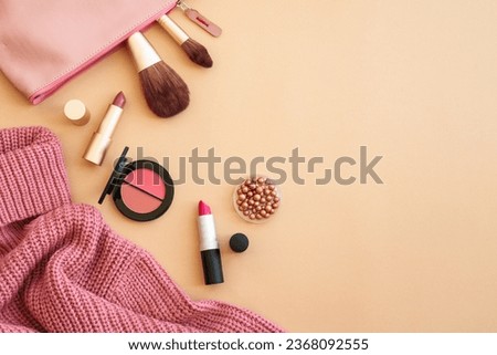 Cosmetic products, make-up with cloth and accessories on color background.