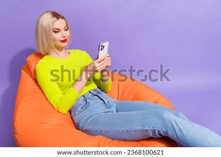 Photo of adorable gorgeous girl blogger wear trendy yellow lime color clothes read comments empty space isolated on purple background