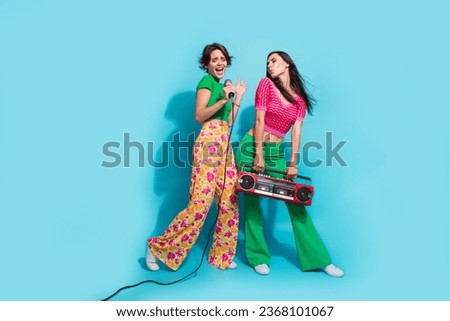 Full body photo of happy two best friends careless singer concert boombox music soundtrack audio isolated on blue color background