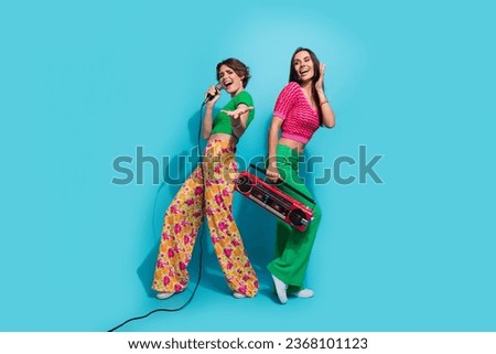 Full body photo of talented singers girls performance concert stage microphone boombox collaborate isolated on blue color background
