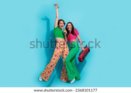 Full body length photo of carefree brunette hair relatives girls sing microphone radio boombox song melody isolated on blue color background