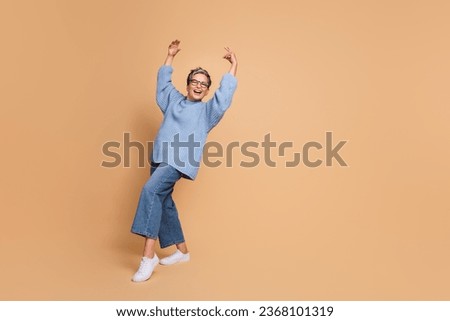 Full body photo of nice overjoyed aged person dancing chilling empty space isolated on beige color background
