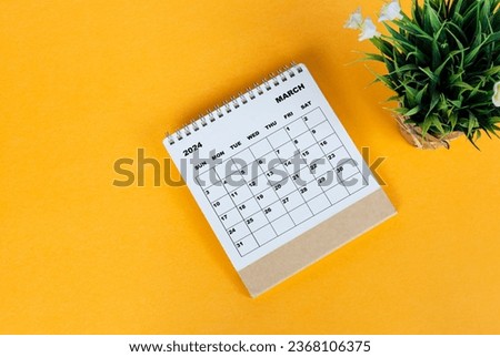 March 2024 desk calendar on yellow background. Directly above. Flat lay. Copy space. Royalty-Free Stock Photo #2368106375
