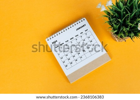 January 2024 desk calendar on yellow background. Directly above. Flat lay. Copy space. Royalty-Free Stock Photo #2368106383