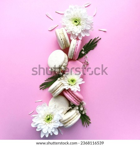 Flat lay photography of delicious macaroons and beautiful flowers