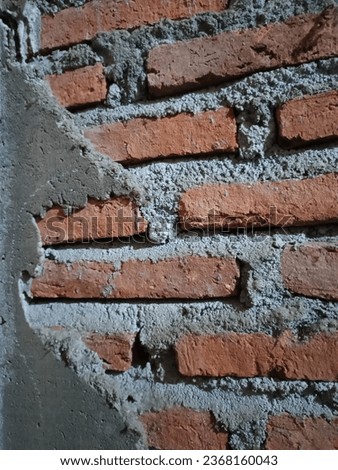 A close-up of a brick wall with a hole in it
