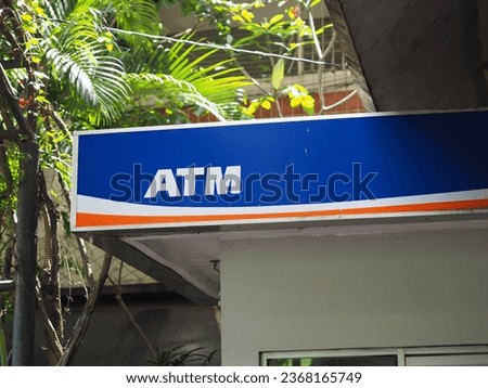 a sign indicating the presence of an (ATM) automated teller machines