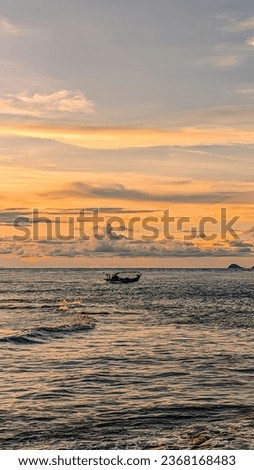 A serene scene of a boat on the beach with the sea and the clouds in the background.
